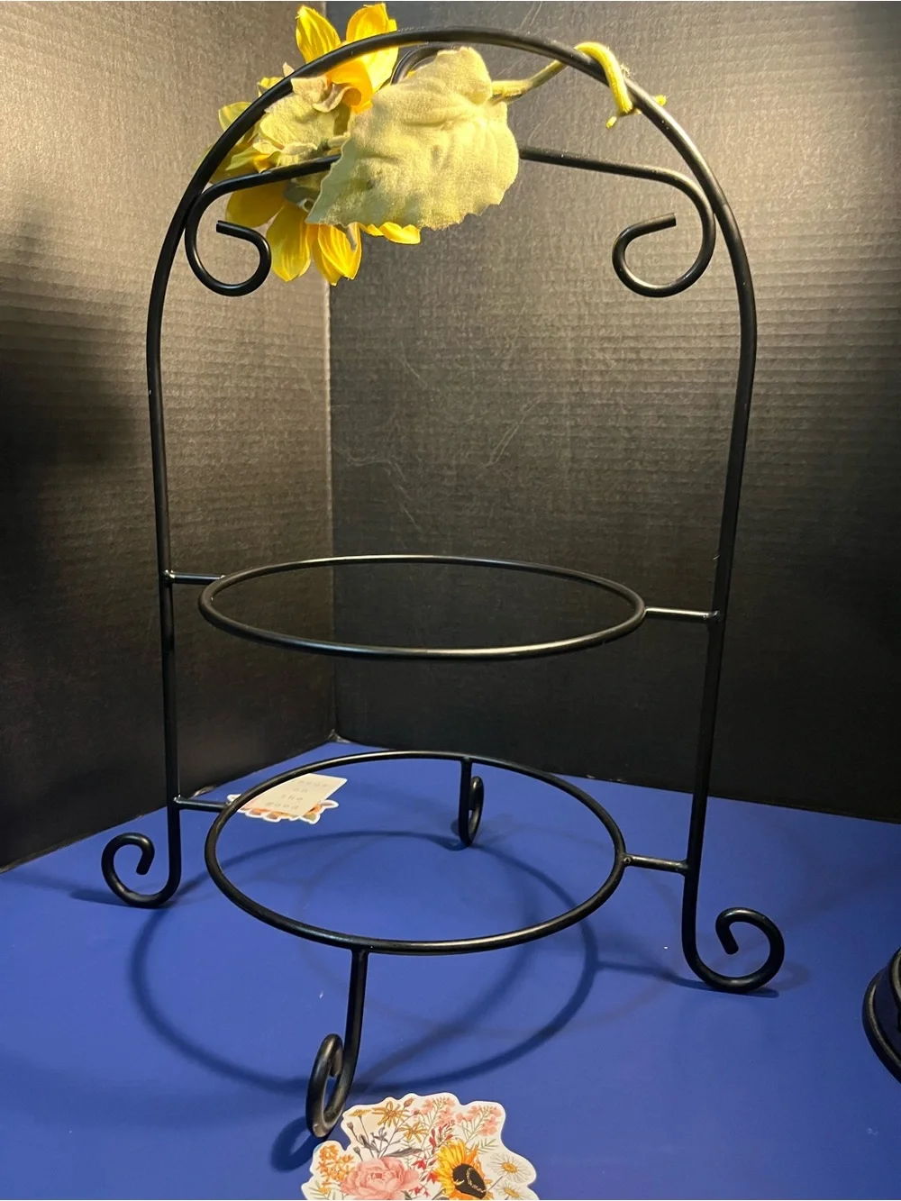 Black Two-Tier Metal Display Stand with Sunflower Accent